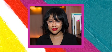 Dhonielle Clayton with books in the background.