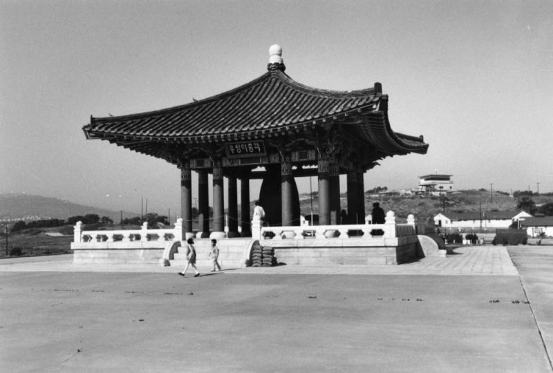 The Korean Friendship Bell in San Pedro with two children playing in front.