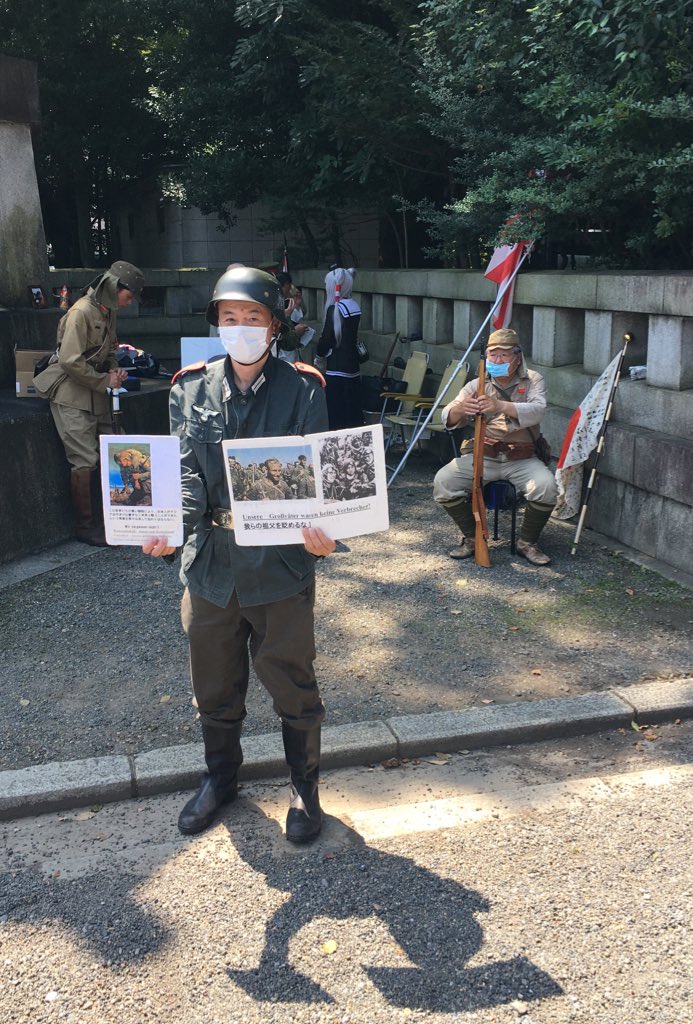 There’s a handful of people dressed up in WW2 uniforms, including a guy in a German Nazi uniform with signs saying "Our grandfathers were no criminals" and "We won’t forget, Japanese-German comradery" in German.