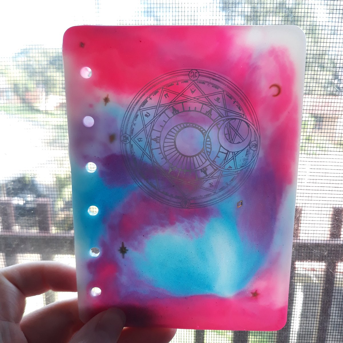 Pandeimonium's tweet photo. Cast this gorgeous notebook. I love how much the colours pop. 
Plus the glow in the dark pigments worked so well.
I just need to procure some more hardware and add some pages.

#Handmade #Resin #CardCaptorSakura #SmallBusiness #DisabledArtist #Notebook #Bookmaking https://t.co/LEXy7hJl56