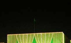 That is allowed a flag after sunset. That building it the Parliament of Pakistan and even there, there must be a light illuminating the flag at all times.You can see the flag at night in this photo.