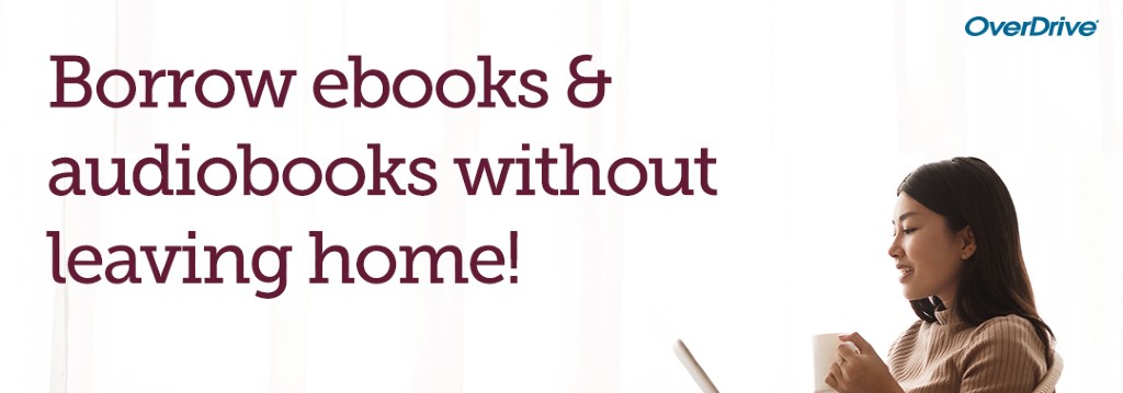 a woman sitting looking at her tablet drinking froma coffee cup