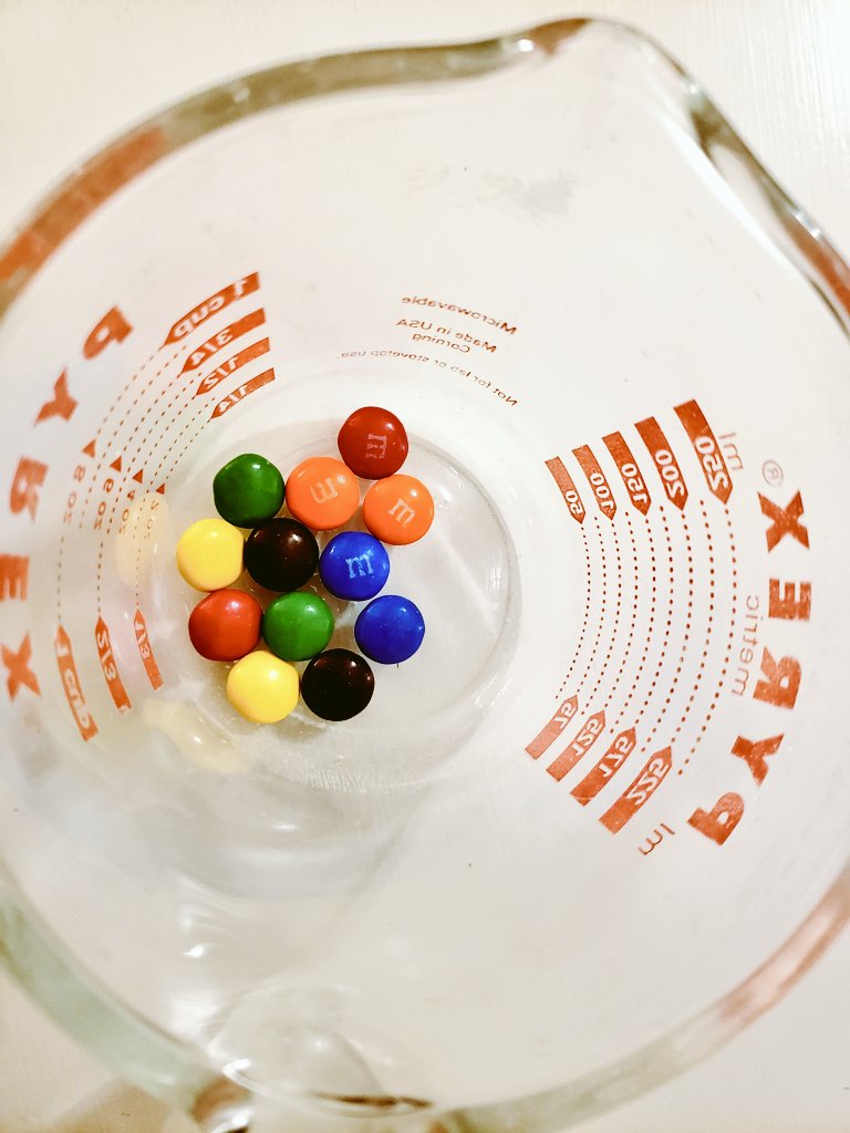 The first step was to remove the shells. To do this, I placed the plain M&Ms in a Pyrex "beaker" and added water.