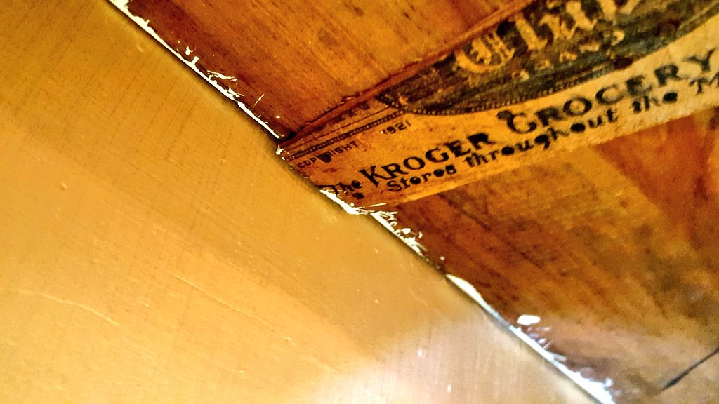 I'm restoring my century-old house and today I discovered a built-in bookshelf is held up by a strip of wood from a Kroger grocery box from 1921