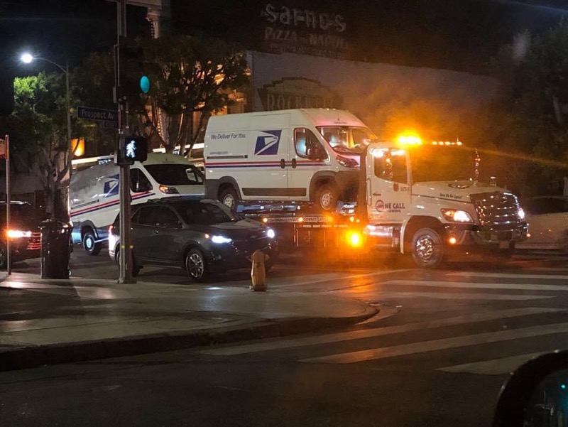 WiseOne323's tweet photo. @_cingraham @jacobbogage Mail trucks being hauled away in West Hollywood. How is the Republican party allowing their toddler to get away with criminal activities??? #HowLowTrumpWillGo USPS https://t.co/HceDMmqvWS