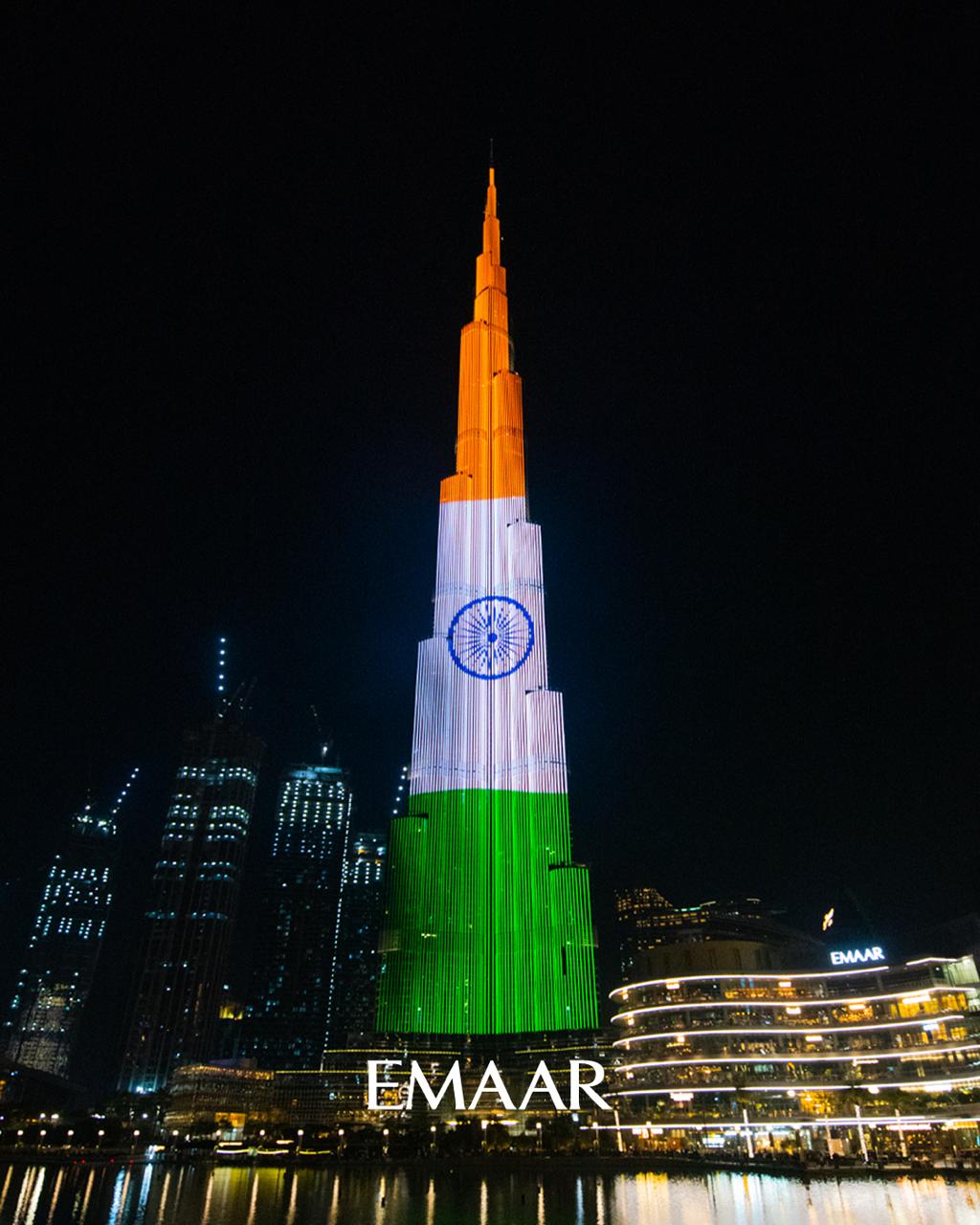 Adnoc Group tower in Abu Dhabi and Burj Khalifa in Dubai lit up spirit