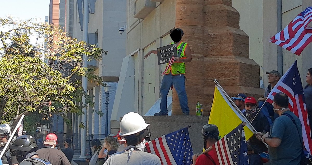 A Black Lives Matter protester had walked over to the far right rally to display his signSome calls to "get him out of here" but no action so far