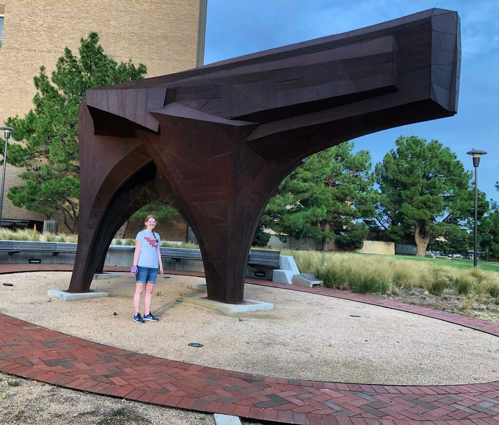 volotr's tweet photo. Is it a gun? An animal? Plaque says “Untitled”. Of course. Random red raider included only for scale. #dropoff #byeCorinna https://t.co/k6XvkmiWP8 https://t.co/43p6v4feWG