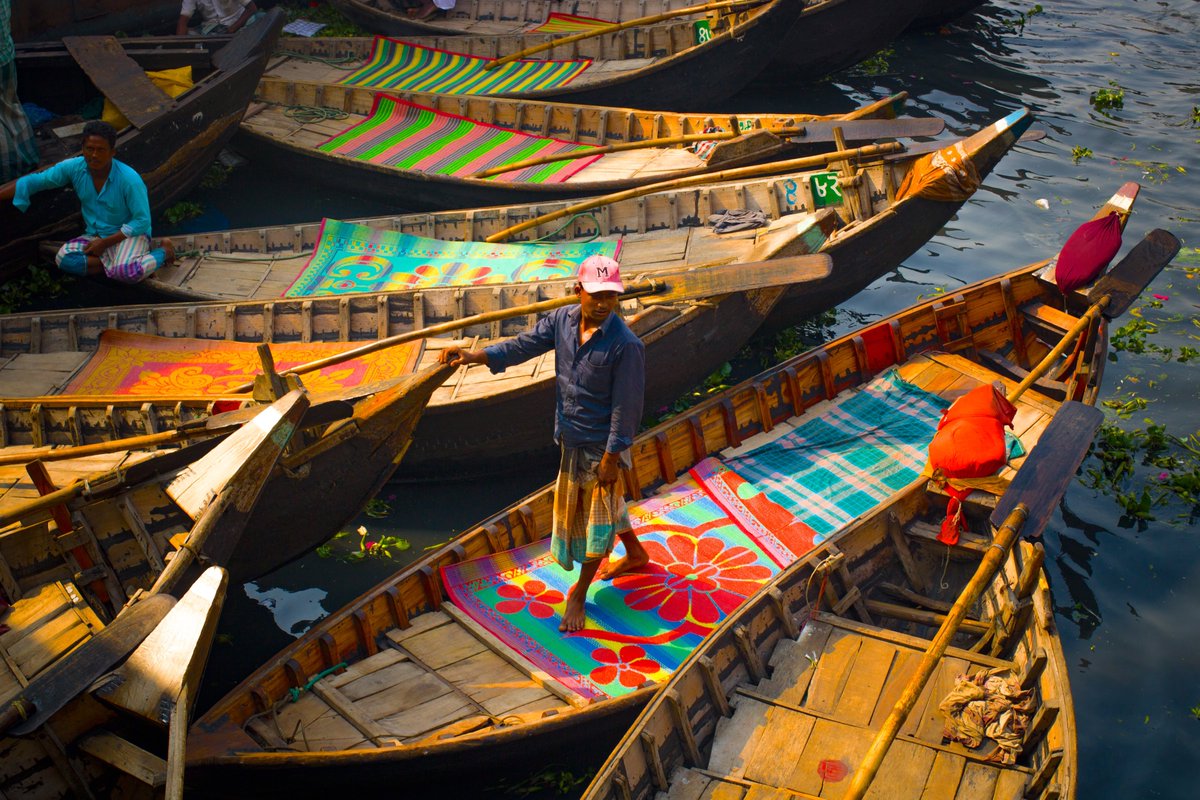 JourneysOff's tweet image. A ferry boatman waits for passengers at Sadarghat Dhaka.