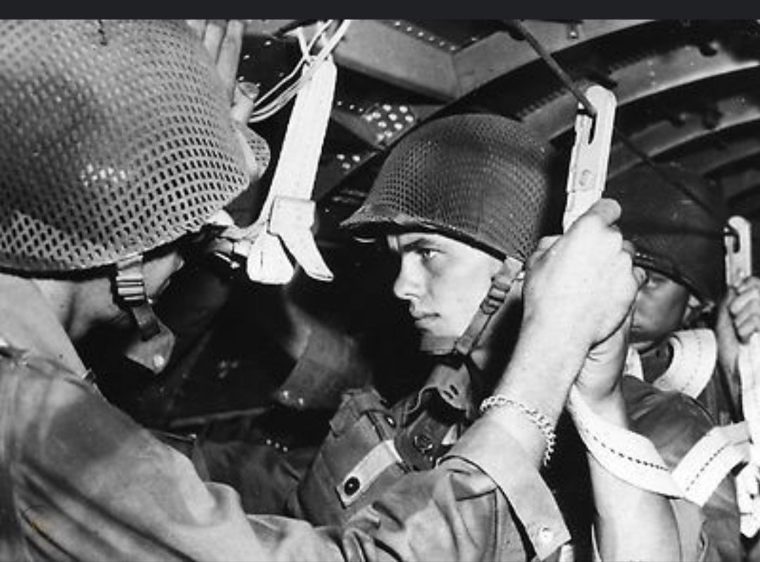 original of a rigger modified helmet of which less than 3,000 were made is now rarer than hens teeth. This great image, likely posed, shows members of the Regiment rigged up to jump and gives us a great look at the helmets. A combination of black and green paint was used. /5