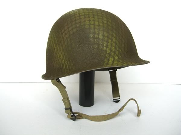 chin-cup, as seen on this original. Two simple buckles were applied to the regular chin strap for the improvised chin-cup to fix into. This image of a very well made reproduction shows how this looked when worn. The Regiment also adopted a tight, British style helmet net that /3