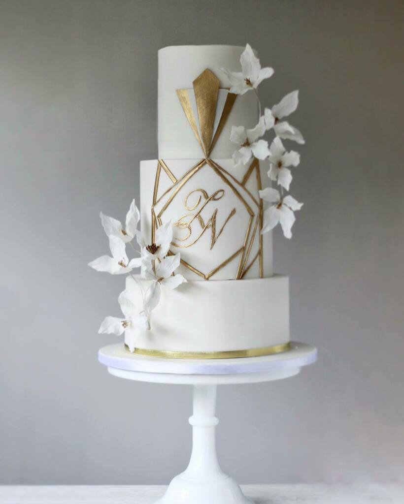 Hint of Art Deco with white sugar flowers for N&amp;Z this month. .
.
.
.
#sugarflowers #nikahcake #artdeco #gold&amp;whiteweddingcake  #yorkshireweddingcakes #yorkshireweddings #ornatecake #luxeweddings #scrollcake #luxuryevents  #cakesofinstagram  #sheffieldca… instagr.am/p/CD9PKibgwsf/