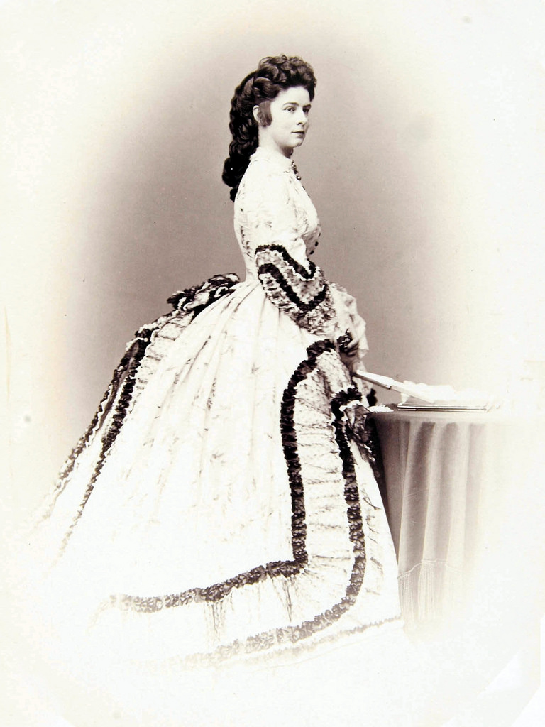 In her youth Elisabeth followed the fashions of the age, which for many years were cage-crinolined hoop skirts, but when fashion began to change, she was at the forefront of abandoning the hoop skirt for a tighter and leaner silhouette.