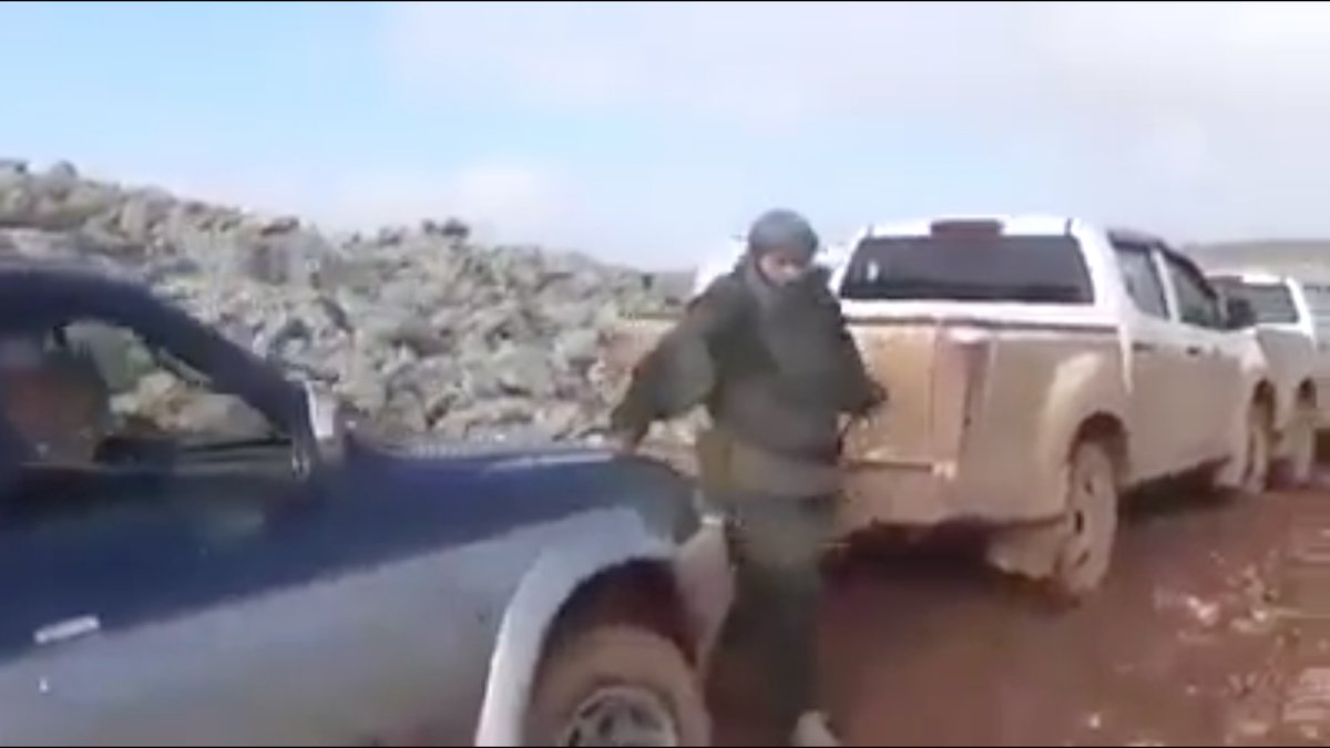 I have no idea what this HTS fighter is wearing.He was one of the men who stopped a jihadist convoy cold and killed all the running terrorists. Whatever he's wearing, it's FUNCTIONAL, not decorative.And he hates being filmed.