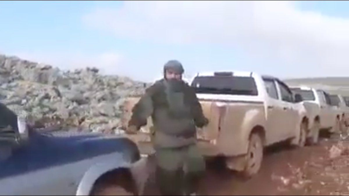 I have no idea what this HTS fighter is wearing.He was one of the men who stopped a jihadist convoy cold and killed all the running terrorists. Whatever he's wearing, it's FUNCTIONAL, not decorative.And he hates being filmed.