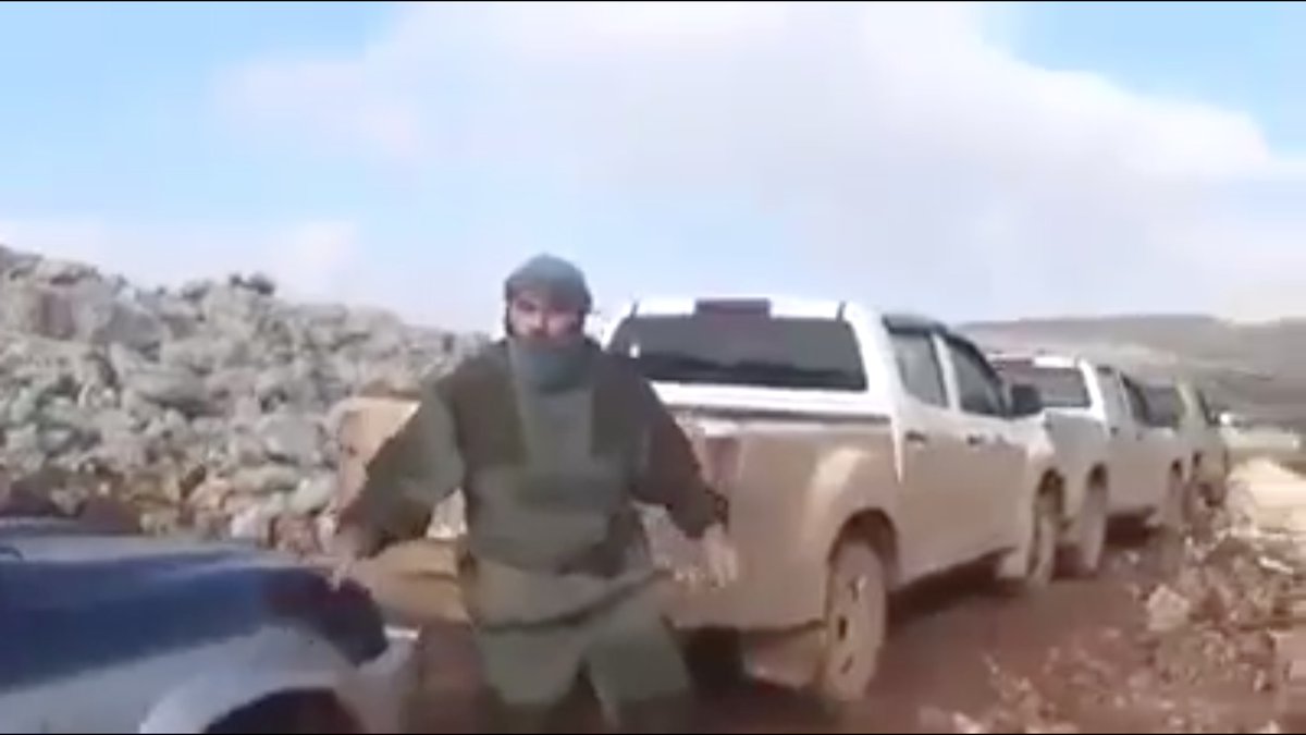 I have no idea what this HTS fighter is wearing.He was one of the men who stopped a jihadist convoy cold and killed all the running terrorists. Whatever he's wearing, it's FUNCTIONAL, not decorative.And he hates being filmed.