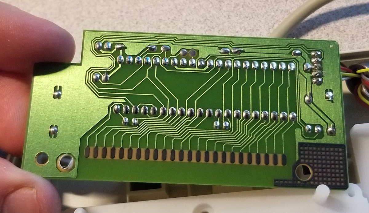 The main PCB is over here, and has no components on this side.It's using one of those awful pressure-fit connectors to talk to the membrane