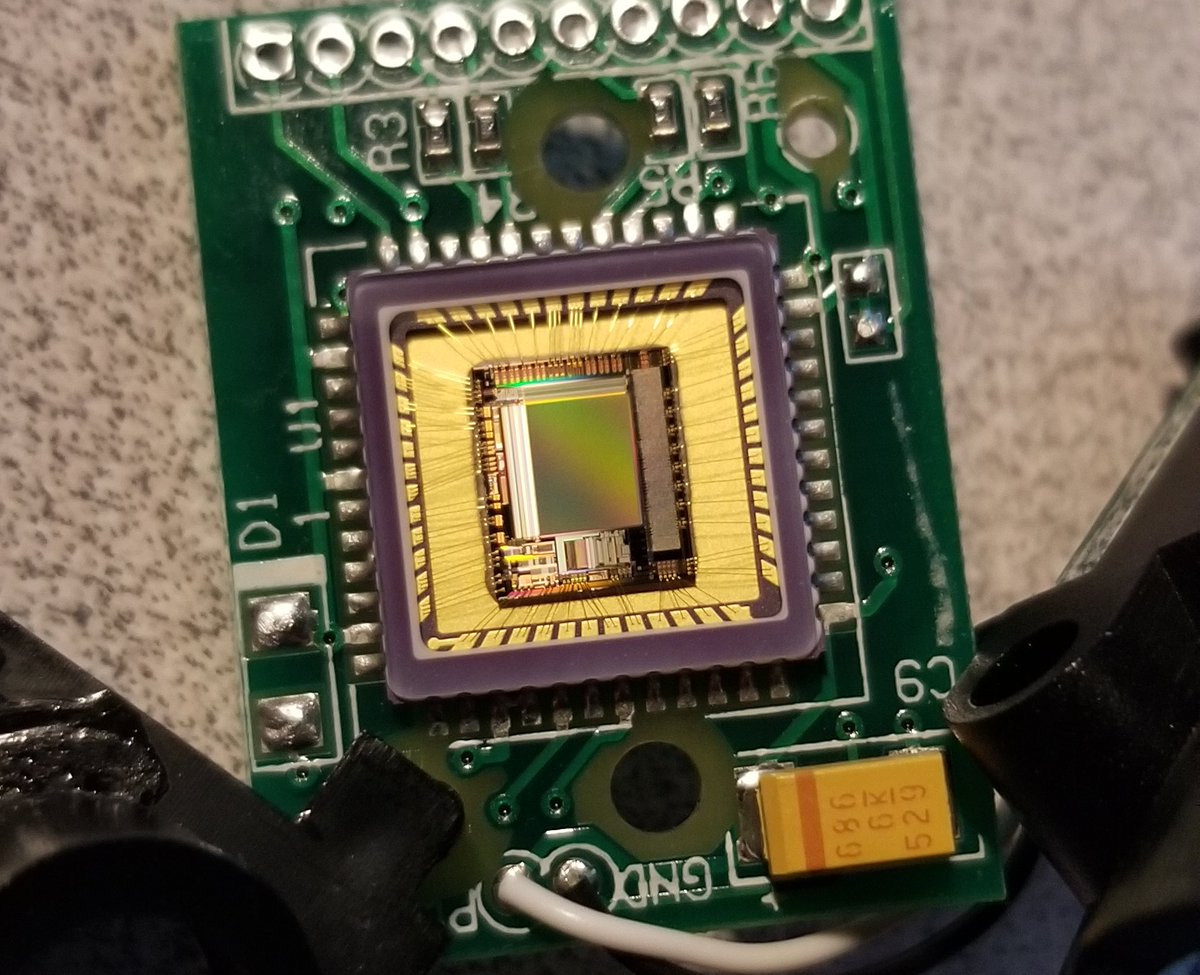 Under that, there's this lovely looking IC.It has to be transparent on top because it's a CCD, but I think this is a hybrid chip, with the middle bits being CCD and the bits around the outside being logic