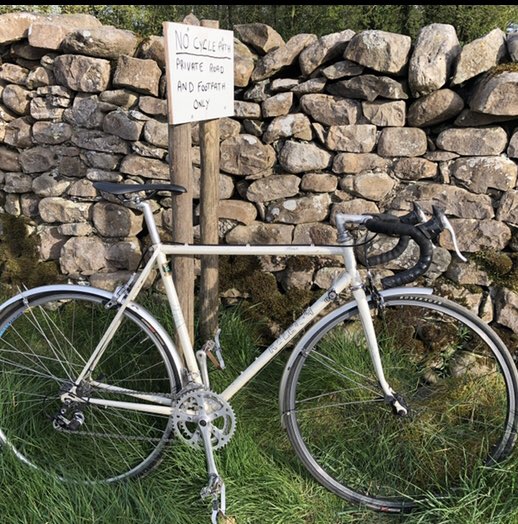 Here’s the first sign (with a bike I made up against it). It’s not very polite and it’s aggressive. And frankly, unnecessary because aside from residents and a few walkers and cyclists, our road is quiet. It’s a dead-end with a bridge and footpath at the end. 2/.