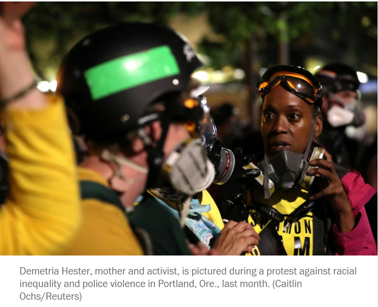 Here he is in a gaggle near Demetria Hester, the leader of the Wall of Moms.