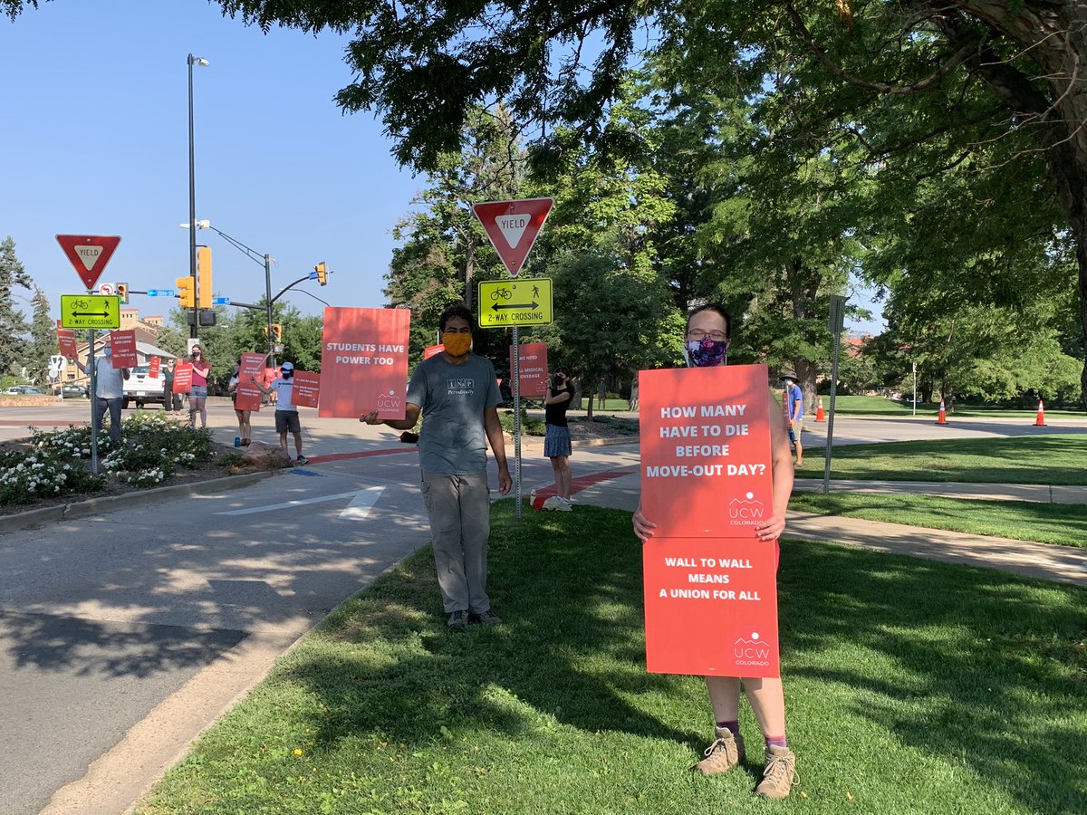 United Campus Workers is Colorado, an employee union, is out best the intersection families turn in. Emma Cating’s sign says “how many have to die before move-out day” Cating is concerned about the density of students on campus during the pandemic.