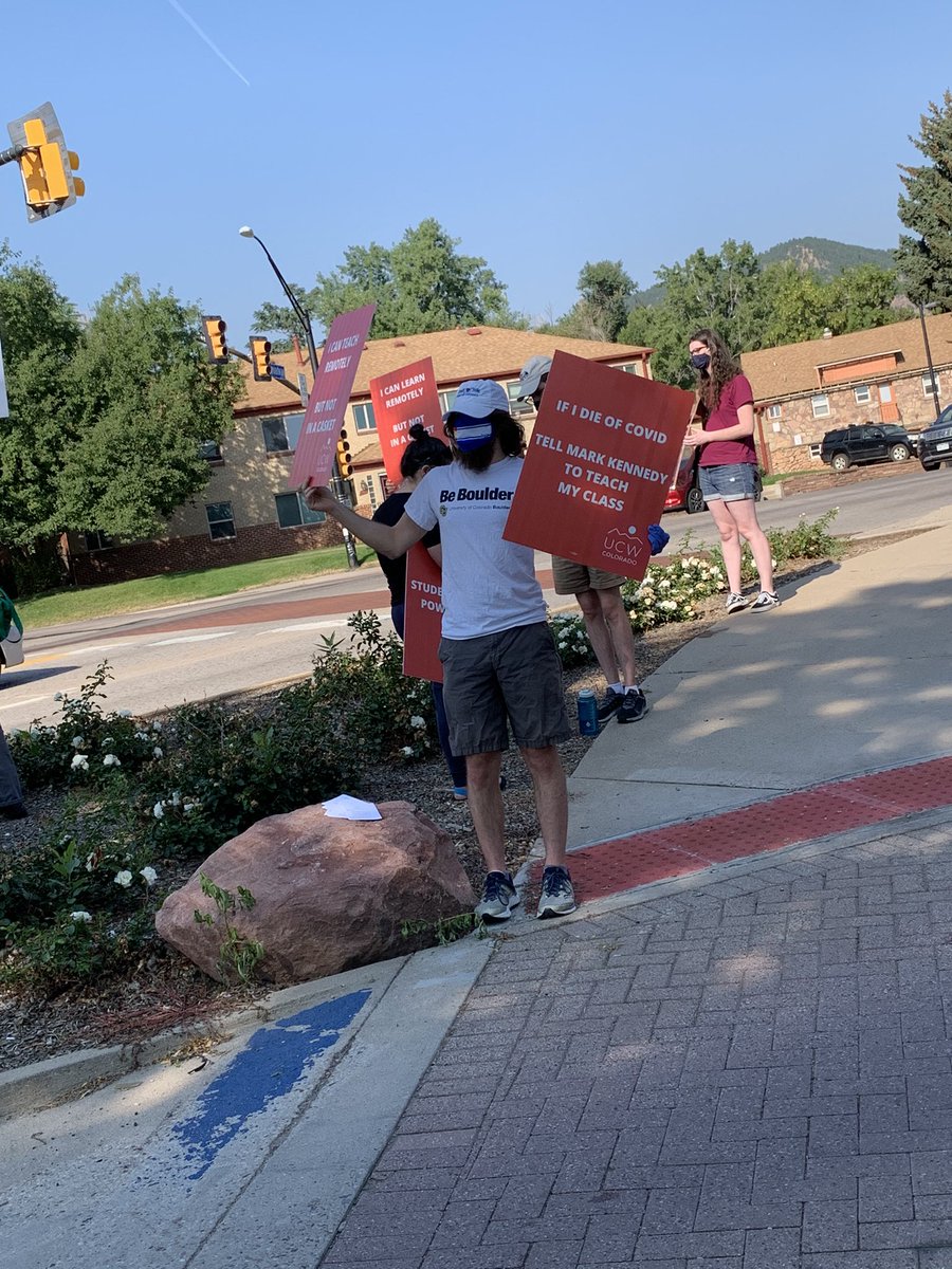 Union President Alex Wolf-Root holds a sign outside  #CUBouder move-in saying “If I die of COVID tell Mark Kennedy to teach my class.”