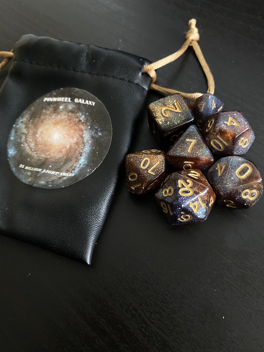 XuAstro's tweet photo. For my TTRPG/astro nerd friends: Ordered some space-themed dice and they came in today! They’re very sparkly, I’m a fan. https://t.co/lrurfAhH54