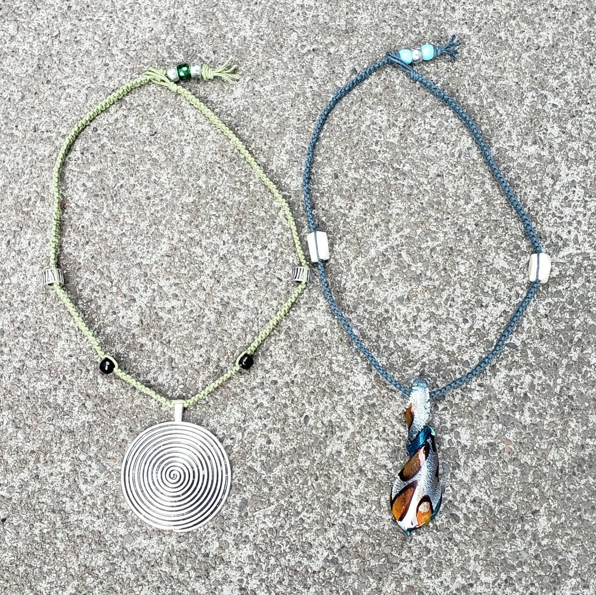 Two freshly knotted chokers available 💙 Check out parts 2 & 3 of this thread to see each necklace individually (1/3) #handmade #macramechokers #hempjewelry #glassbeads #bonebeads #glasspendant #metallicpendant #knotty_introvert_creations