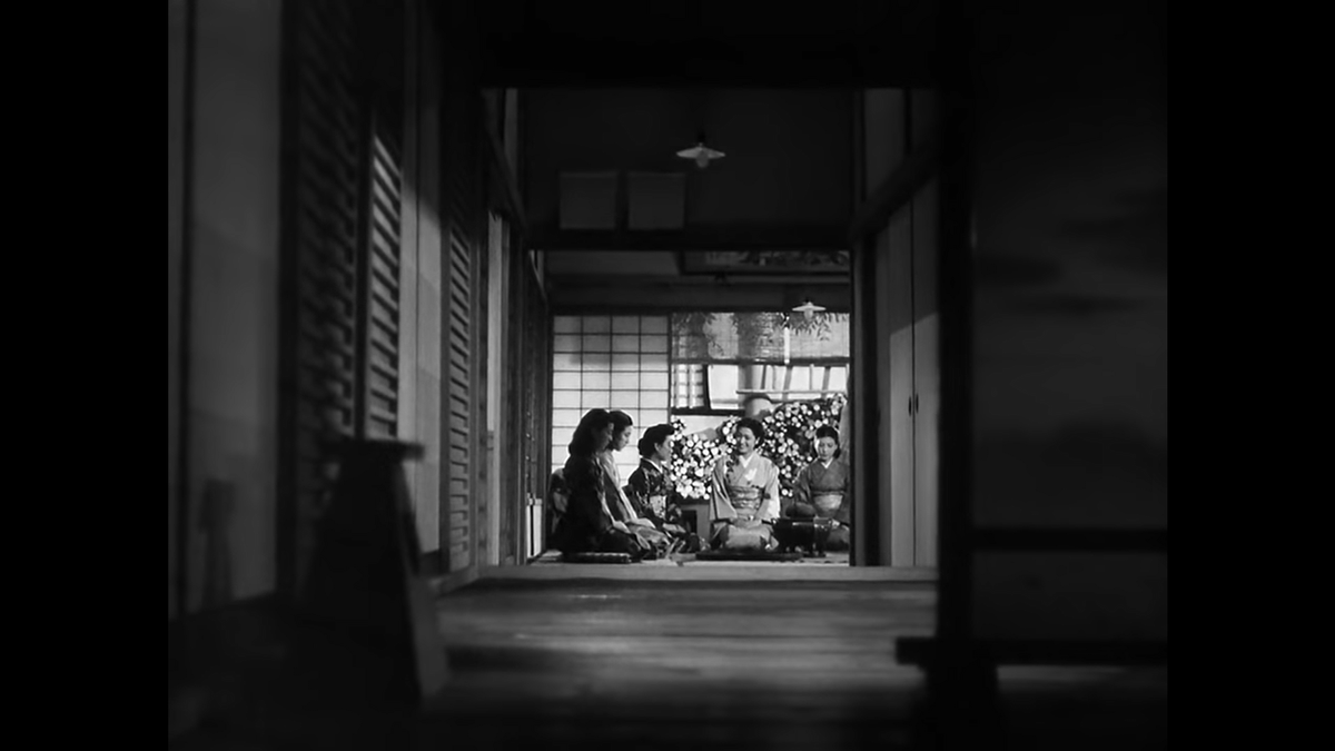 Our first shot with people is down a hallway; we can see a group of women in kimonos before another woman arrives and bows. This is our star and protagonist, Setsuko Hara as Noriko. Note the characteristic low angle and geometric structure of the composition.