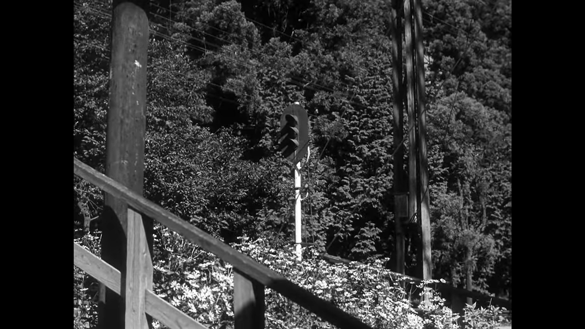 The final shot at the train station in this sequence appears to be back on the stairs from the first shot, albeit from a different angle to center the train signal.