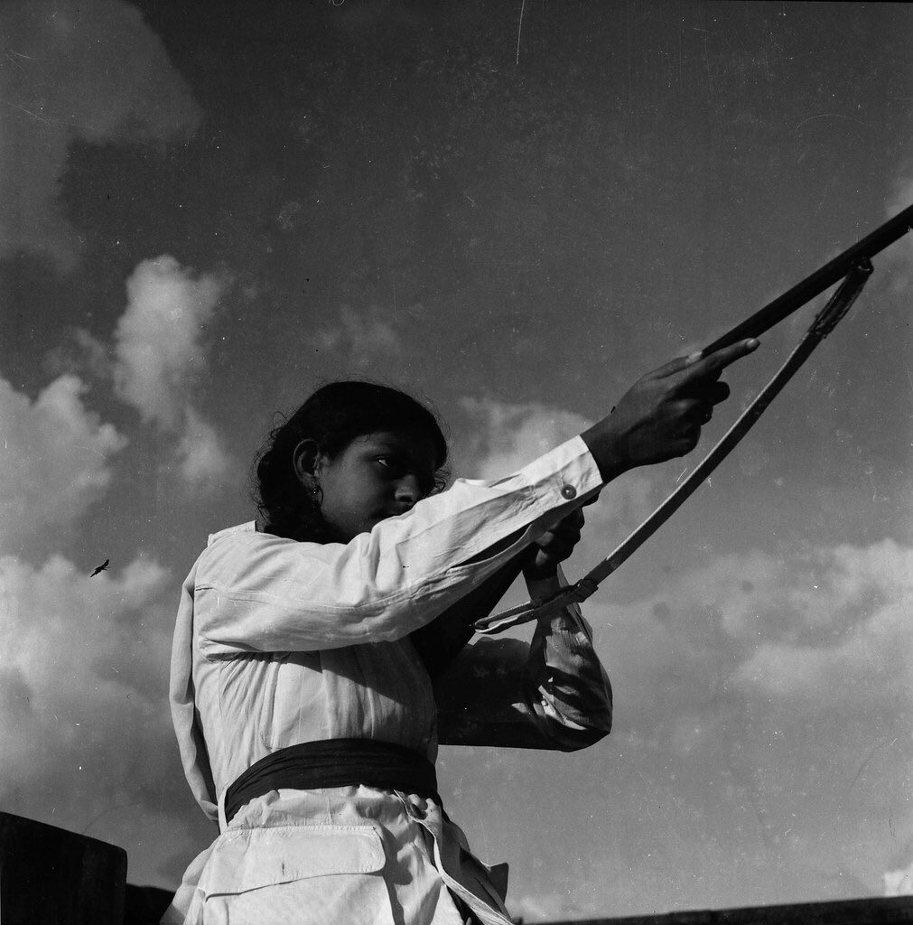 Khanam had her first international exhibition in 1956 after participating in the International Photo and Cinema Exhibition, Cologne.Photo Caption: A woman takes combat training during Liberation War. Dhaka, Bangladesh. 1971. (Photographer: Sayeeda Khanam)