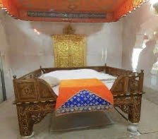 This practice is still continued in Darbar sahib as a mark of remembrance and respect. At the Sukhaasanasthan (in Akal Takht sahib) one would find a white sheet,placed underneath the asthan of SGGS ji (representing the place of rest of Guru Arjan Dev ji)