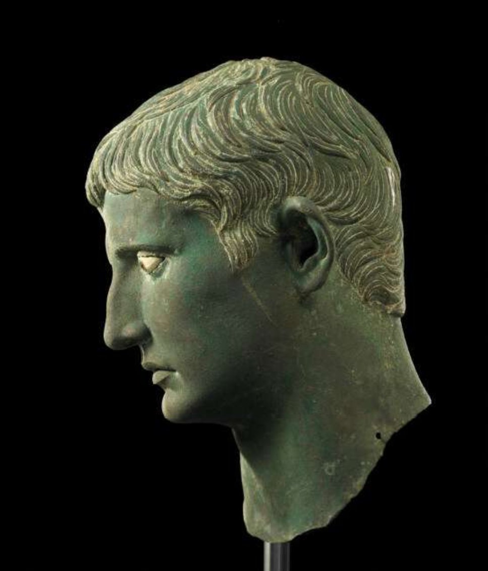 The head likely comes from one of a series of statues that Augustus had set up in Egypt following his victories over Antony and Cleopatra. The modelling of the head in bronze, with eyes of glass and calcite, was designed to communicate power to the newly acquired Egypt.