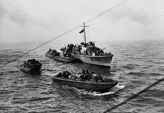 Landing craft draw away from a motor torpedo boat to make their run at the beaches at Dieppe. 19 August 1942. LAC MIKAN: 3194301.