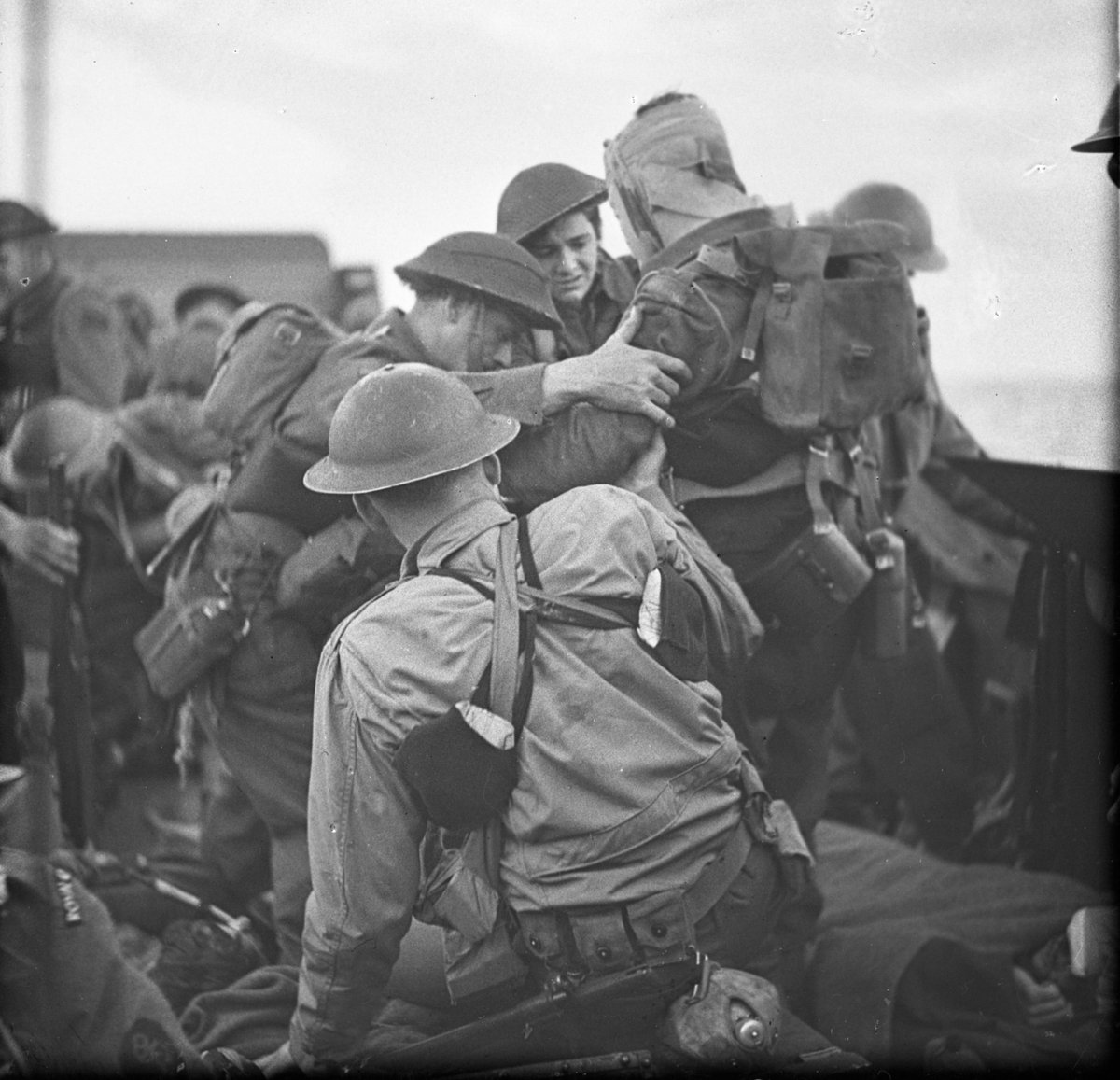 Wounded Canadian troops being loaded onto a vessel during the raid. Dieppe, 19 August 1942. LAC MIKAN: 4976319.