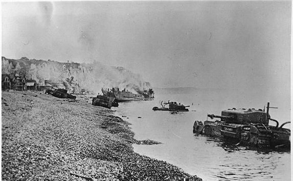 Wrecked allied tanks and landing craft, along the beach at Dieppe, following the failed raid. 19 August 1942. Department of National Defence.