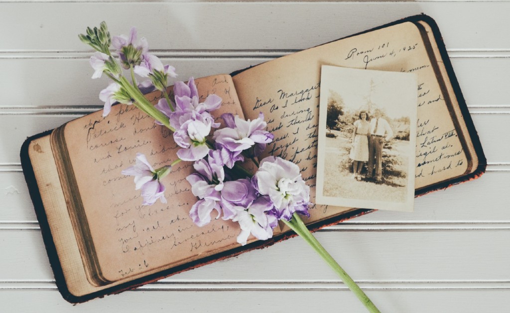 a vintage photo album with flowers on top