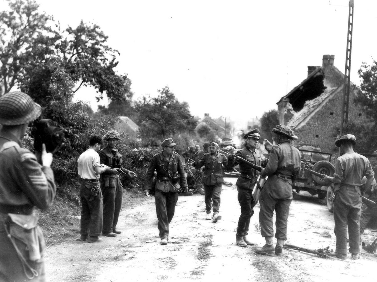 Closing the gap. Amazing photograph taken today of Major Vivian Currie, with pistol on left, closing the Falaise Gap. The image is said to be the only one from WWII of a soldier in the process of winning the Victoria Cross.  #WWII  #Canada 