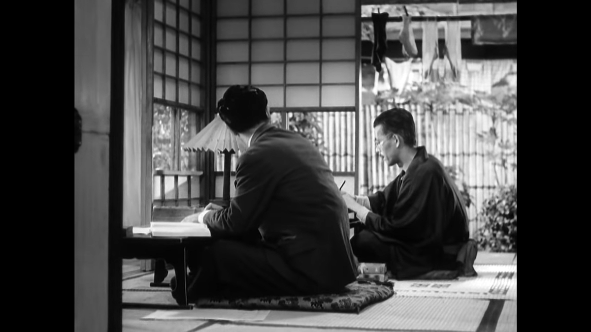 Compare this repeat shot to the flipside shot two cuts earlier and it’s clear that Usami has been moved. Here he is closer to the wall they are both facing, but in the reverse shot he is further back. This is characteristic of Ozu, who valued aesthetic appeal over continuity.