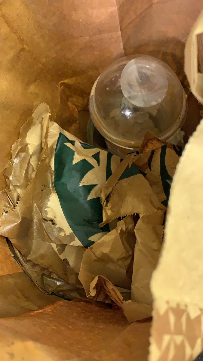 DyerMisba's tweet photo. @ubereats_uk this is how your driver deliver food. Don’t even apologise can clearly see the whole bag is wet from leaked coffee. Nothing but ice left in the iced coffee!!!!! Ridiculous! https://t.co/rzk6kCPMa0