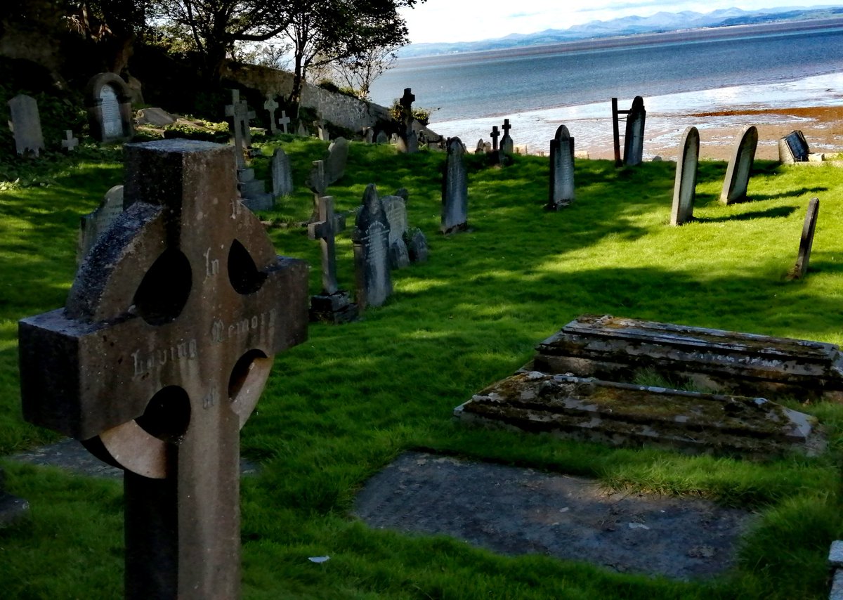 The compact church has a graveyard that gently slopes down to the sea
