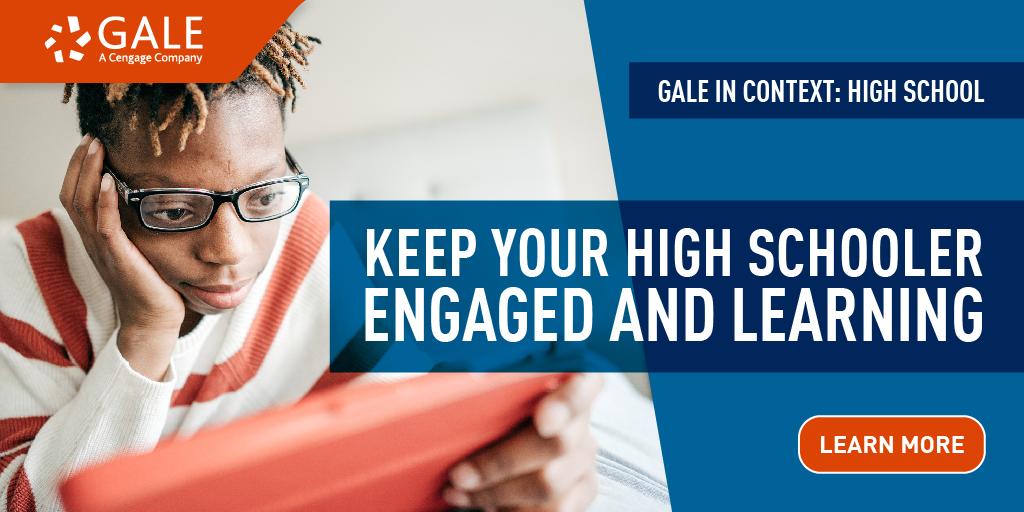 a young Black male teenager wearing glasses looking down at his tablet in his hand