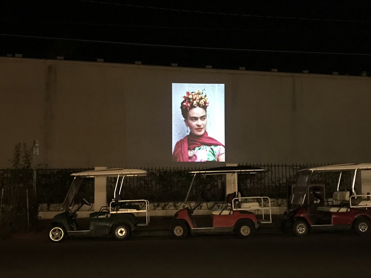 Experience our exhibition, “Frida Kahlo: Through the Lens of Nickolas Muray,"" with our outdoor projection series. Now through Sunday, Sept 27, we're featuring photographic portraits and prints of Frida Kahlo nightly from 8 - 10 p.m. along Metropole Avenue and Crescent Street.