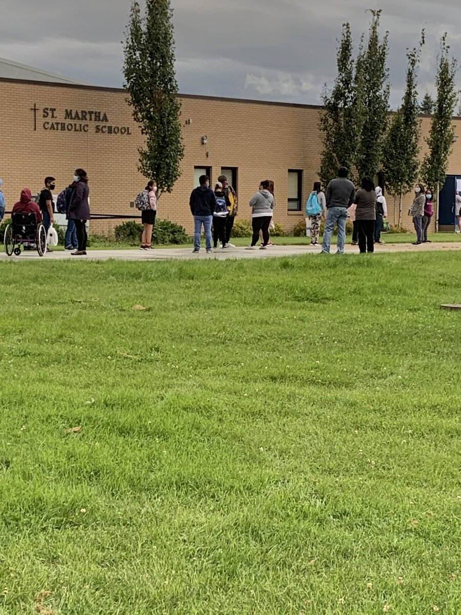 Ph0enixRis1ng's tweet image. This is the back to school chaos. Everyone is lined up on orange spray painted markers for social distancing. Children &amp;amp; staff are masked, w/ some wearing shields. As always, proud to be a part of this school division. @AdrianaLaGrange @CMOH_Alberta @EdmCathSchools #abed