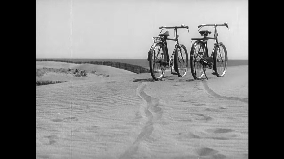 A lovely composition, using the fence to connect to the rest of the sequence but focusing on both the bikes and their tracks leading out from the foreground.