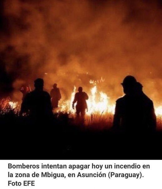 "Firefighters try to put out a fire in the Mbigua area, in Asuncion. (Paraguay)”