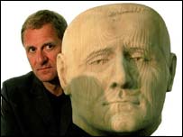 study this photo again: Motion alongside a gigantic model of his own head. This head is allegedly a bust by Jilly Devon, in possession of the National Portrait Gallery. But it has not been on display to the public since..... 2005