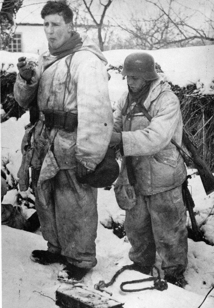 Possibly the most meh of pics to date. Men buddying up, typically when getting combat kit on. I’d suggest he’s ensuring kit is distributed well, with tactical attention to securing items to mitigate noise. When time is available to do this, you take advantage of it. 25)