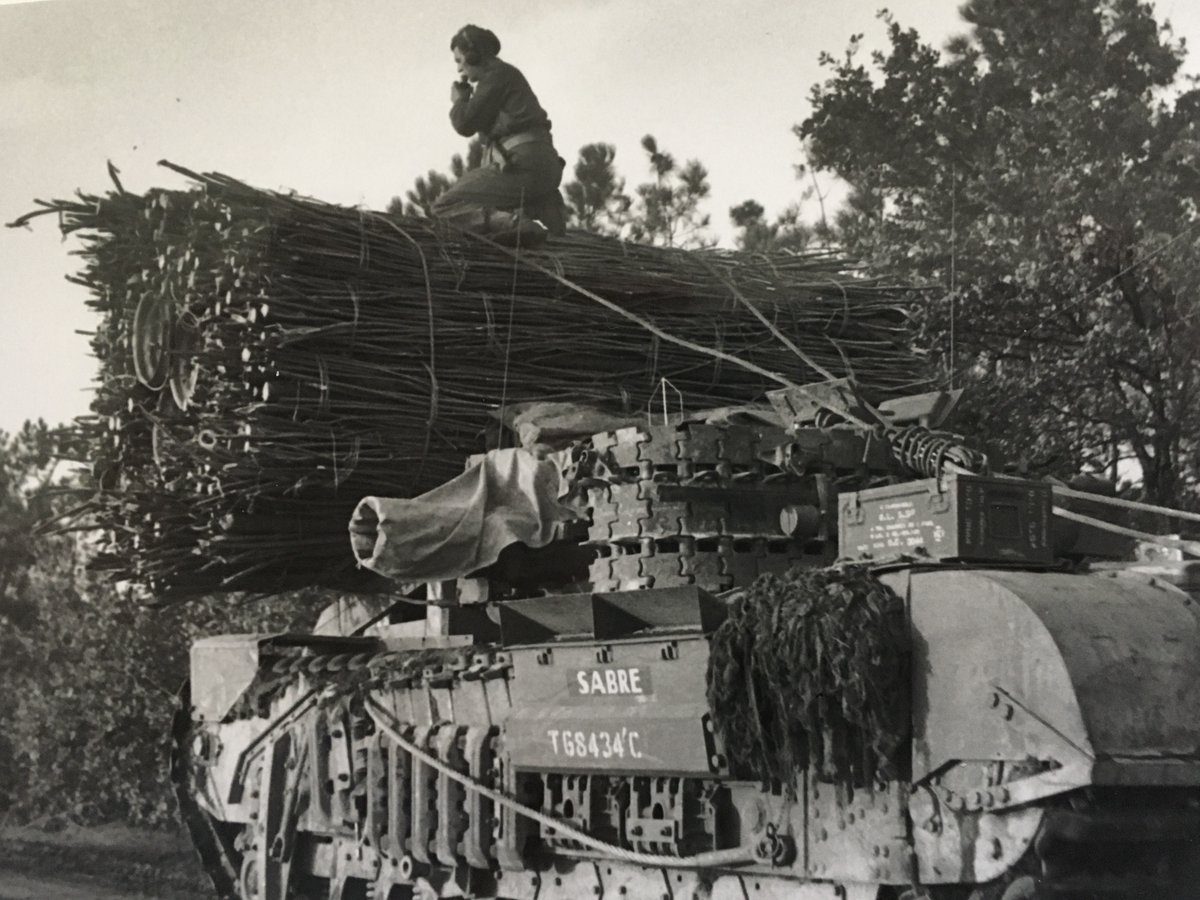The most common device carried by 79th AD AVREs was a fascine. These were used to fill ditches to allow vehicles to cross, or occasionally placed against walls. Here is a well-known photo, the turret at an angle because of the fascine, the commander giving the driver directions 1