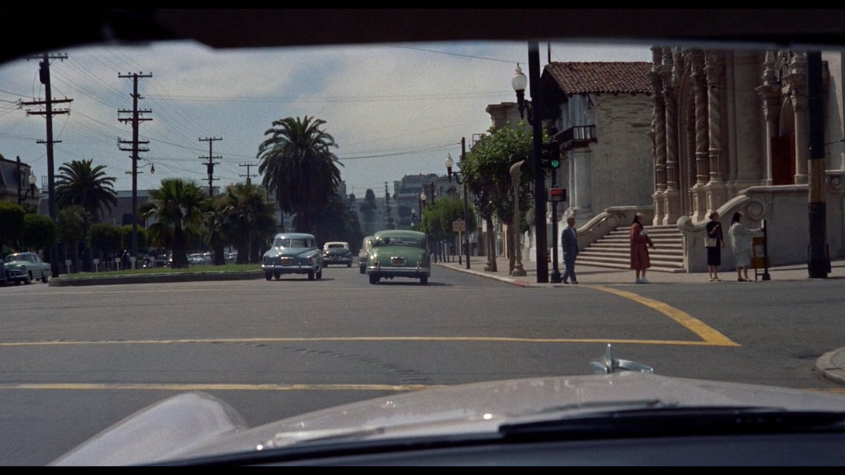 i've read about the constant downhill shots during the tailing sequences but has anyone written something about... driving a car & supposedly having full freedom of motion but being restricted by the duty to tail a specific other car? which makes this whole sequence feel on rails